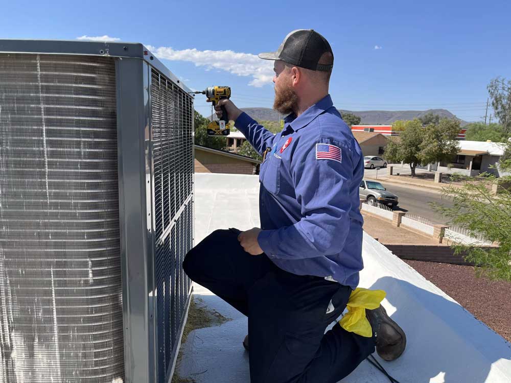 tech-working-on-ac-on-roof