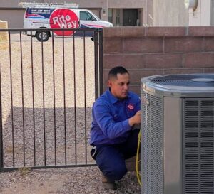 Rite Way technician tuning up a heat pump with the Rite Way truck in the background