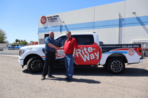 Rite Way technician and 88 DRAINS technician shaking hands in front of Rite Way work truck