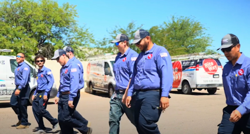 Rite Way team members walking together in front of Rite Way-branded vehicles.